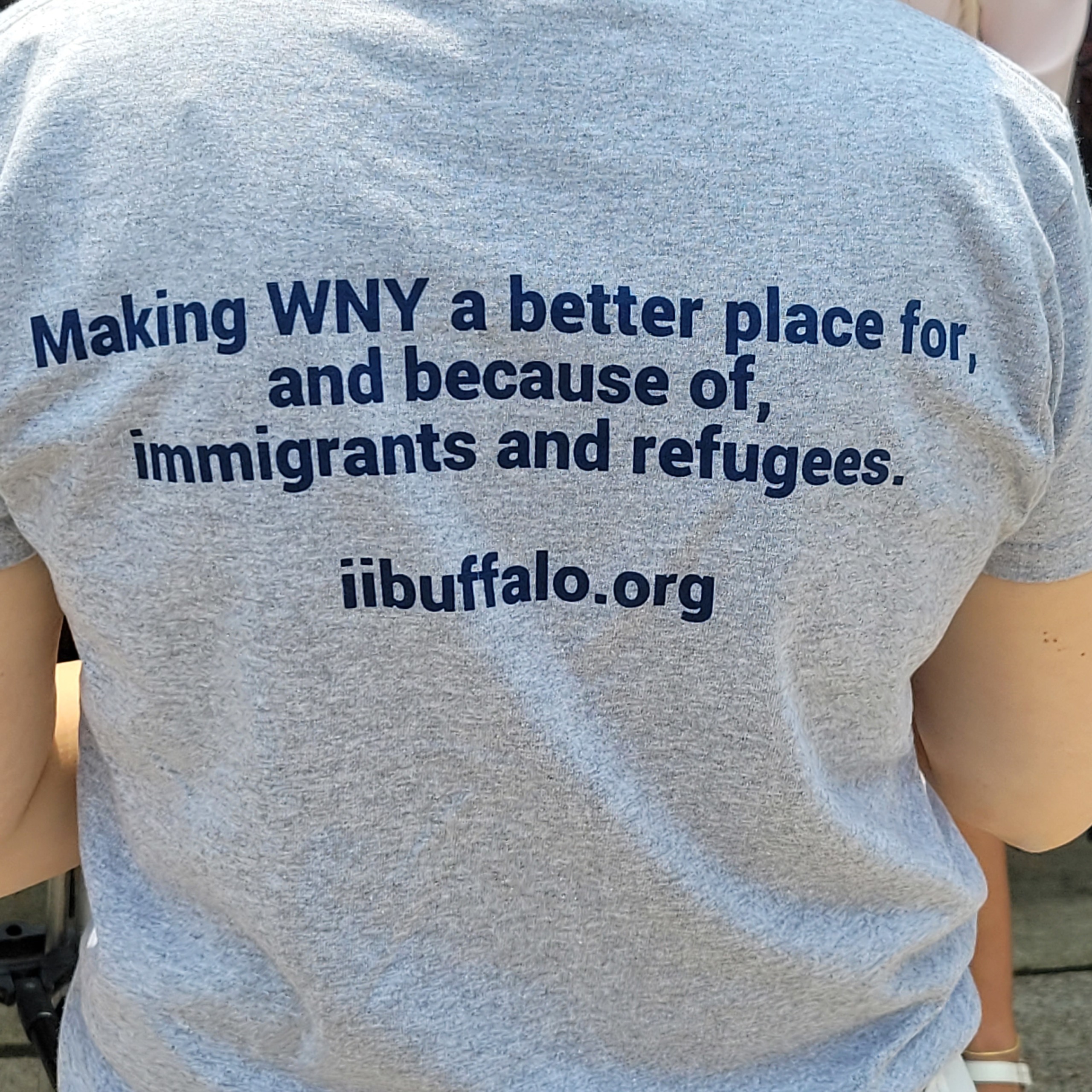 Tshirt with the words, "Making WNY a better place for, and because of immigrants and refugees."